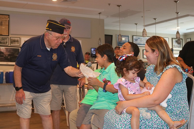 Post member Steve Cole chats with the Ward children before presenting them with medals of appreciation.