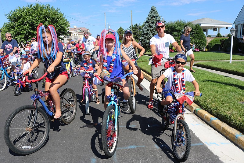 Families pictured in the 2022 Gardens Civic Association Bike Parade make it an annual tradition.