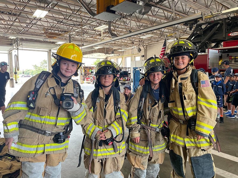 The junior firefighters get into teams for "firefighting" during the camp.