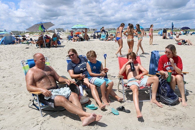 Dave and Andi Frearson, of Ambler, Pa., with their children from left, Jase, Jack and Layne, enjoy the beach day.