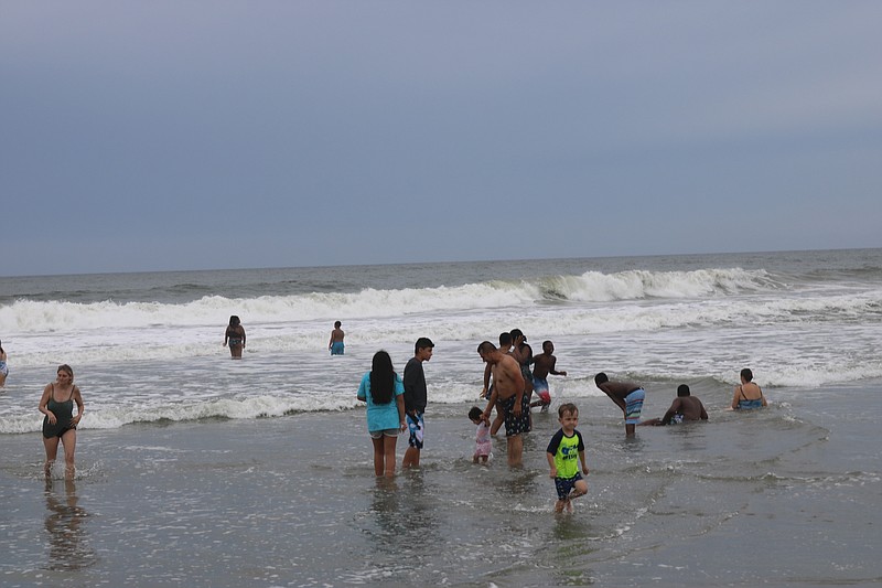 Bathers waded in the water.