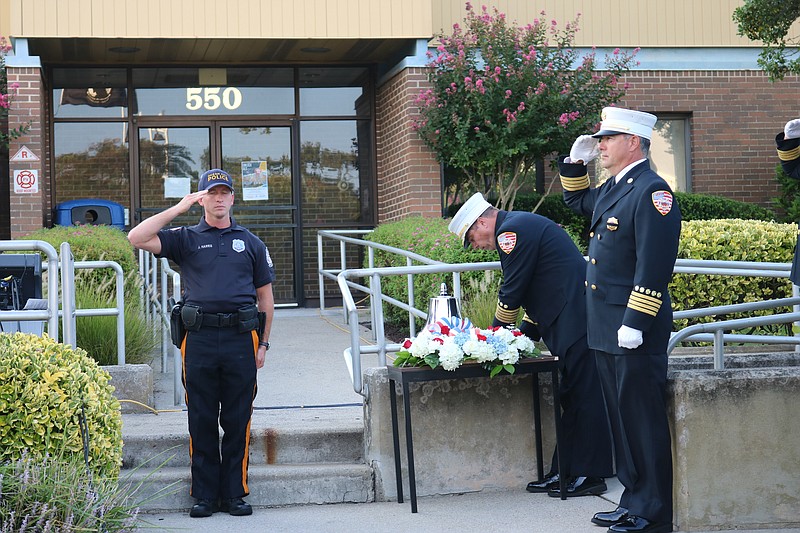 Ocean City Fire Chief Jim Smith strikes a bell in a tradition that commemorates fallen firefighters. 