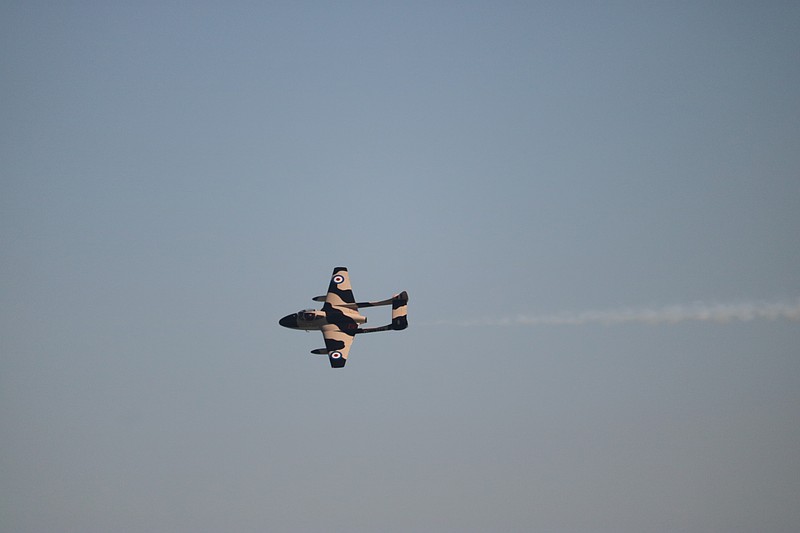 A World War II-era jet makes a pass at high speed.