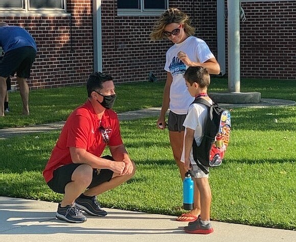 Students get to chat with teachers on the way into school. (Photo courtesy of JASM Consulting Inc.)