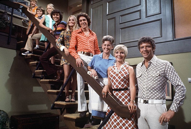 Barry Williams, in orange shirt, is shown with his TV family during the heyday of the 1970s hit "The Brady Bunch."