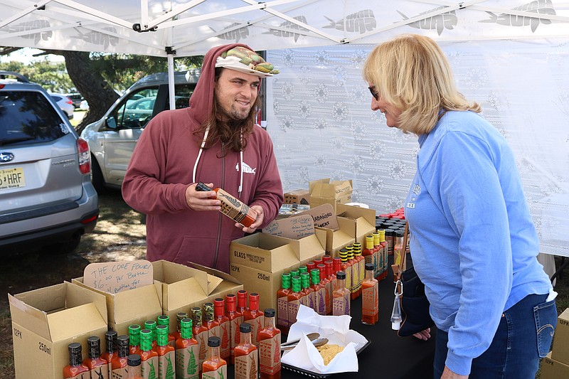 Gerry Schmidt, of Ocean City, gets some advice on hot sauces from Pete Pittaluga of Hank Sauce. 