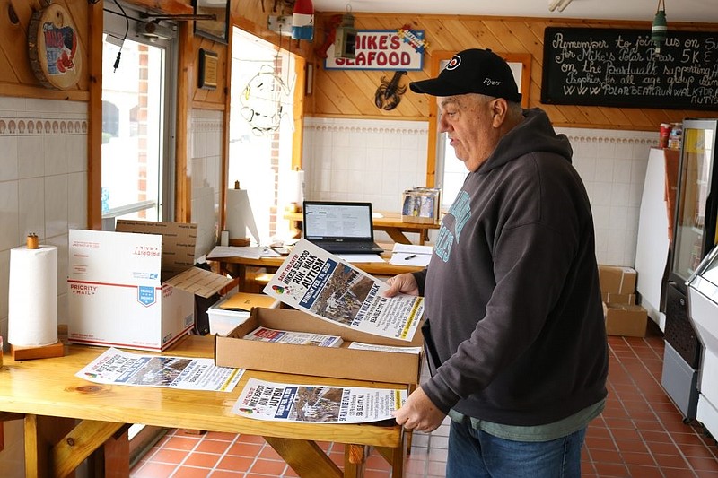 Restaurant owner Mike Monichetti is also a staunch civic booster of Sea Isle. As event sponsor, he is shown looking over posters for the Polar Bear Plunge Run-Walk for Autism fundraiser.