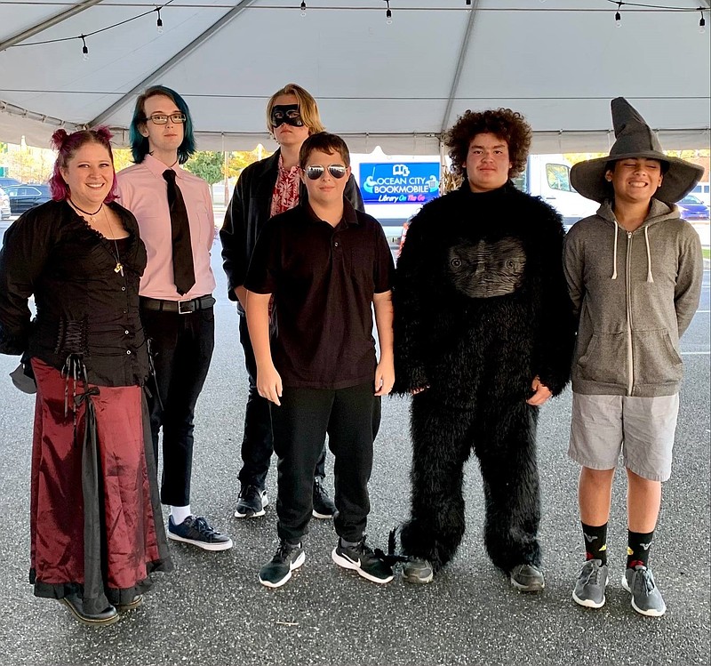 Participants in the library's Young Adults programming host the Murder Mystery Dinner under the tent. (Photo courtesy of OCFPL)