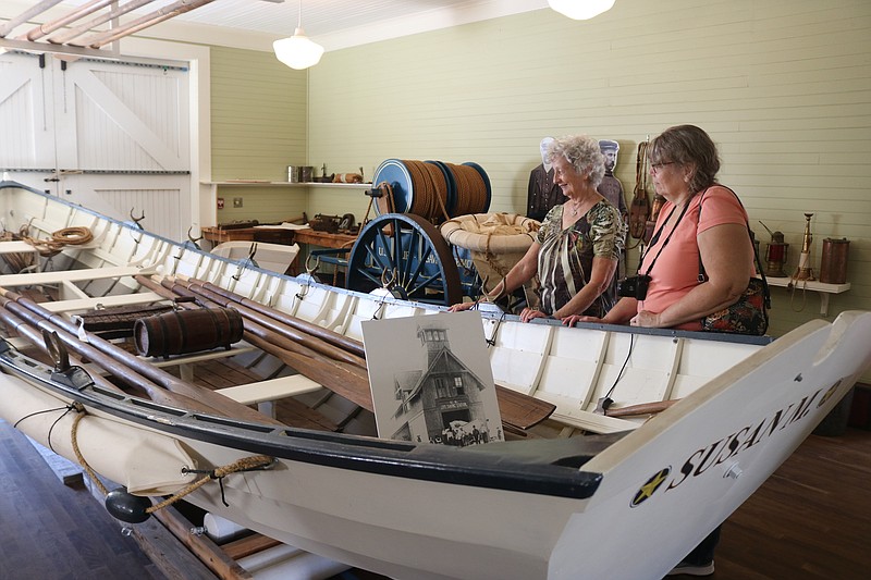 Margaret Papai and her daughter, Liza Dingman, look at one of the surf boats that were used to rescue passengers and crew members from shipwrecks off the Ocean City coast.