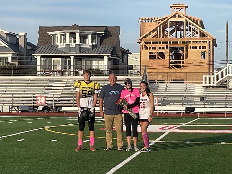 The Helphenstine family, Kyle, Clint, Mikenzie and Andi, pose at midfield to honor Mikenzie's commitment to the Ocean City field hockey program in 2021.