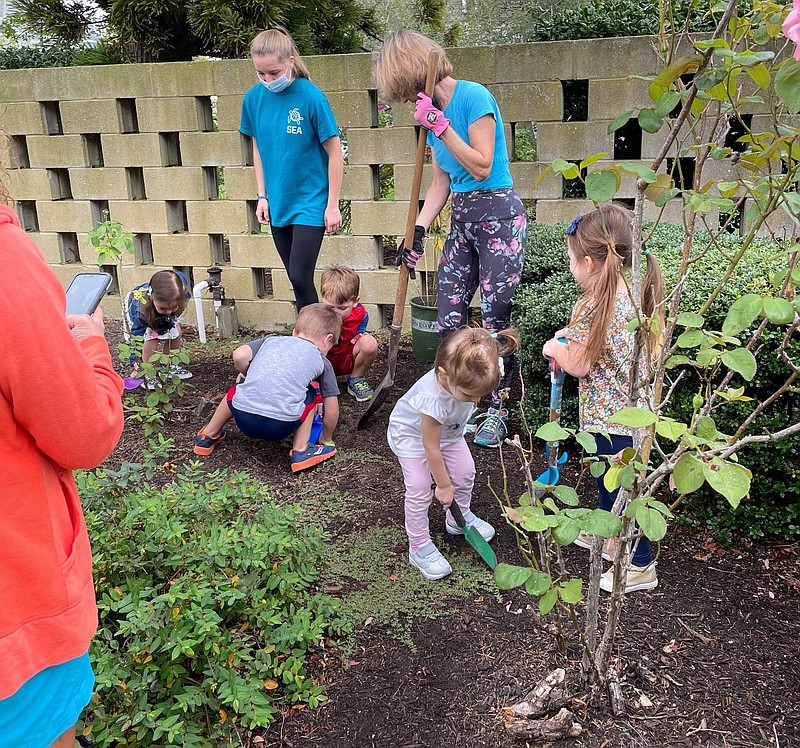 Preschools put their shovels into the ground to help create the monarch butterfly garden. Standing at right is Catherine Cipolla.