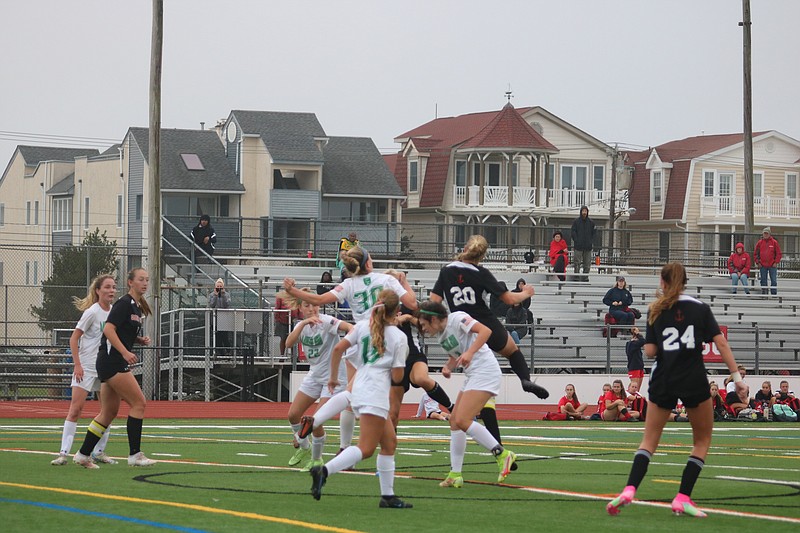 Both teams battle for possession inside the box.