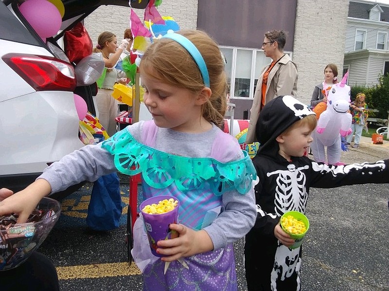 Grace Green, 5, of Egg Harbor Township, chooses some candy as her brother, Joe, 2, looks for some other treats.