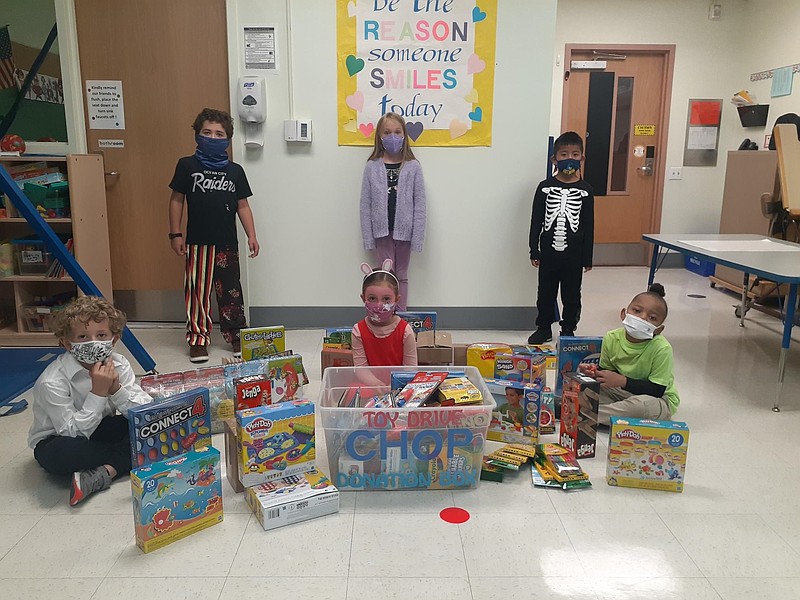 Primary School students display some gifts for the toy drive. (Photo courtesy of JASM Consulting)