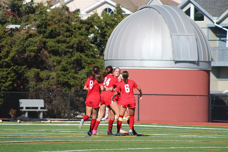 Ocean City embraces after Senior Captain Summer Reimet's first half goal.