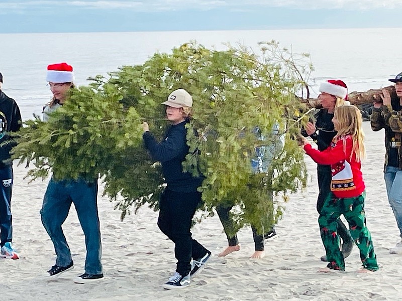 People carry the tree onto North Street beach. (Photo courtesy of Dave Stout) 