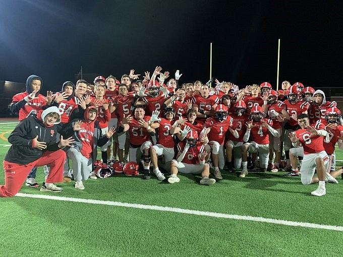 Ocean City's players each flash 10 fingers to celebrate their perfect 10-0 record after beating Mainland. (Photo courtesy of Ocean City High School Football Twitter page)