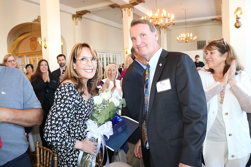 Michele Gillian, executive director of the Ocean City Regional Chamber of Commerce, receives flowers from her husband, Mayor Jay Gillian, after she spoke about her award.