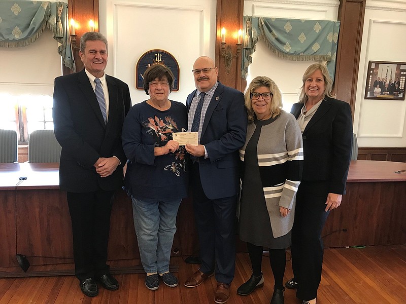 Museum members Kenneth Cooper and Babs Stefano, left, receive a check from Joseph Orazi, chairperson of the Bubble Mania event, and committee members Cynda Hollenbaugh and Maria Marinelli. (Photo courtesy of OCBOR)