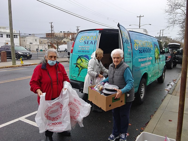 Volunteers Tina Curione, left, and Kathy Thompson, along with Judy Warner, in back, volunteer each year. 