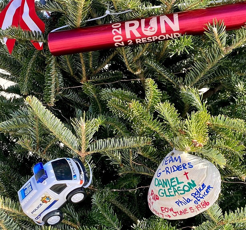 A relay baton ornament is placed high on the tree of the organization Firefighter Five, a foundation to help with veteran first responder's wellbeing. 