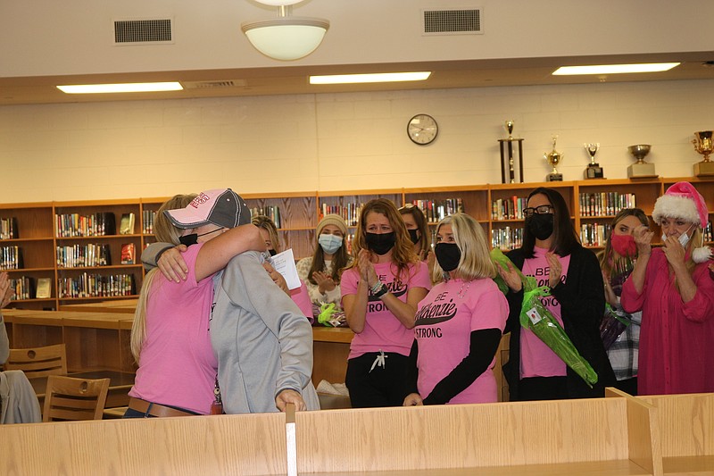 Primary School Principal Cathy Smith hugs Mikenzie Helphenstine, on her retirement from teaching in December of 2021.