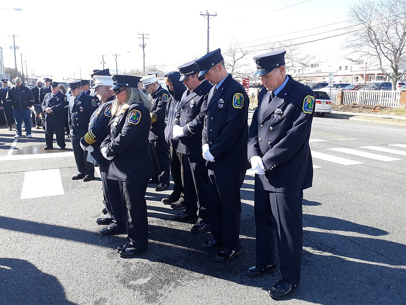 Firefighters bow their heads outside of Coastal Christian in memory of Eric Jones.