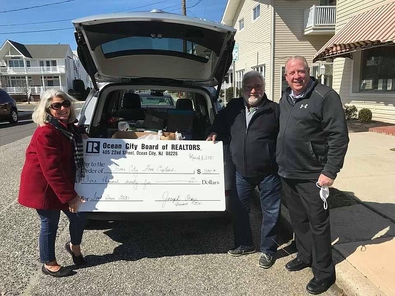 Gloria Votta, left, the 2023 recipient of the Salute to Working Woman award, and fellow realtors, Nick Marotta, center, and Kevin Redmond, during a 2021 food drive. (Photo courtesy of Gloria Votta)