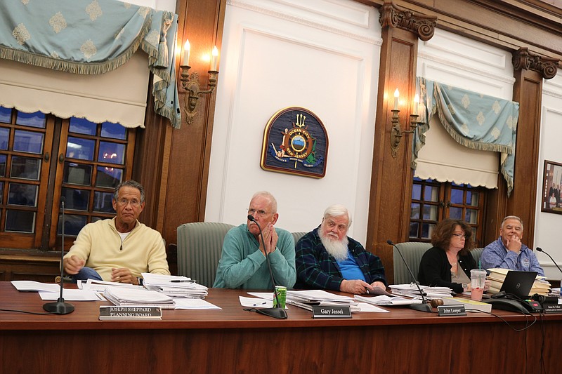 Members of the planning board listen to the presentation.