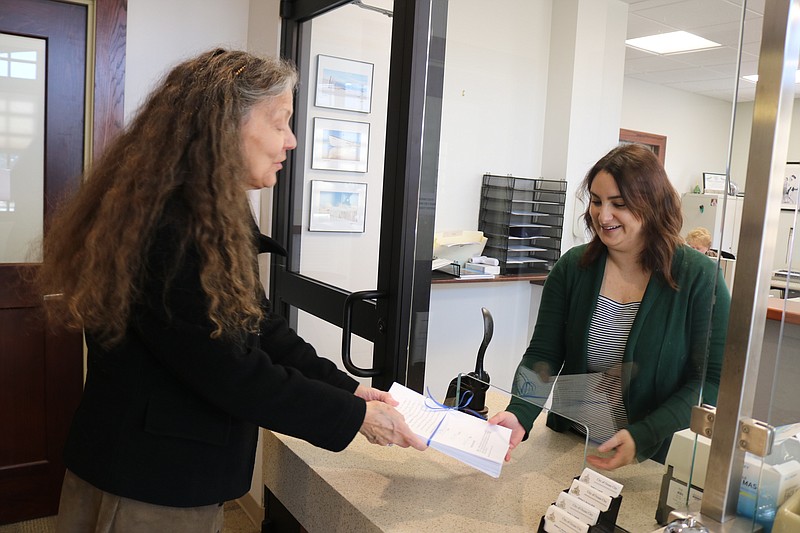 City Council candidate Donna Moore, left, turns in her nominating petitions to City Clerk Melissa Rasner.