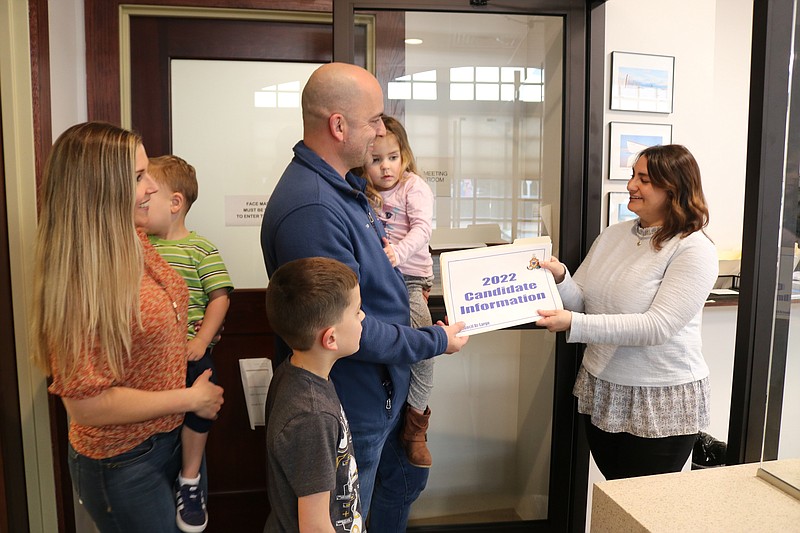 Surrounded by his family, Councilman Tom Rotondi hands his nominating petitions to City Clerk Melissa Rasner.