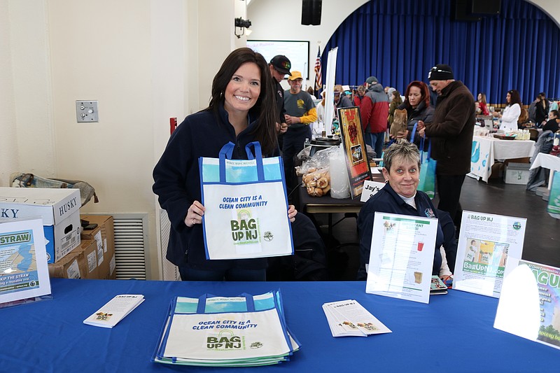 Ocean City Public Works employee Victoria Puga holds up a reusable bag at the entrance to the event with Charlotte Moyer, at right. 