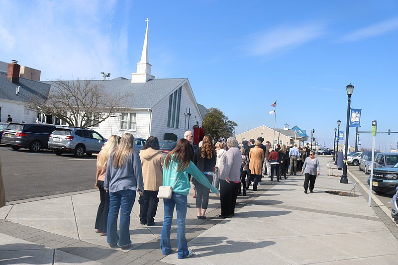 The line of mourners paying respects to Travis Waid wraps around the United Methodist Church in Sea Isle City.