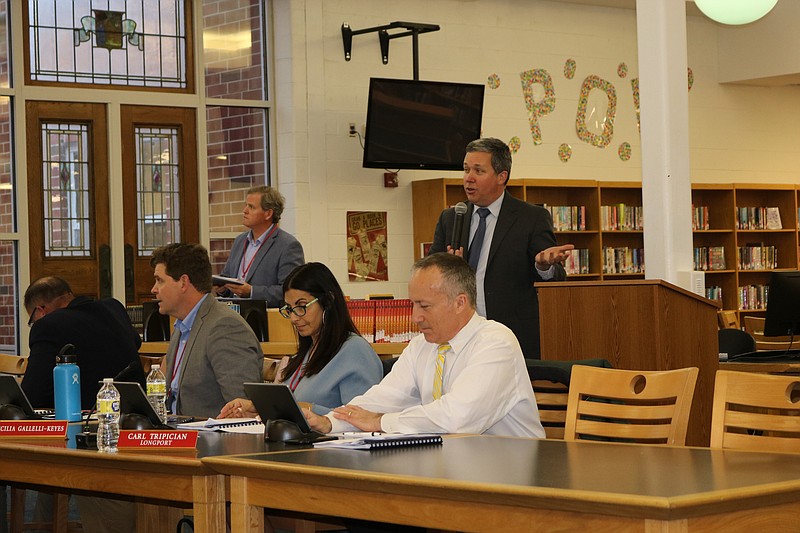 School Business Administrator Tim Kelley, holding microphone, goes over the 2022-23 school budget. 