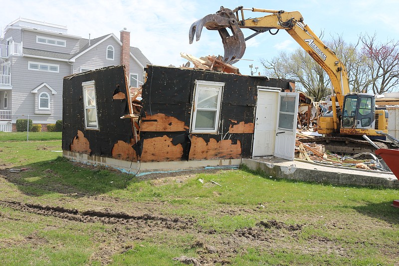 In April a claw takes away chunks of the old senior housing cottages at Peck's Beach Village.