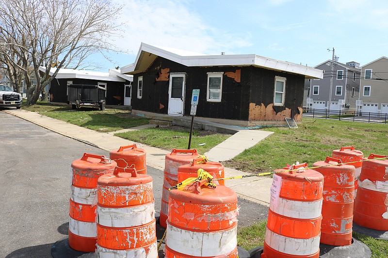 Some of the old cottage-style homes, stripped of their exterior siding, still must be torn down.