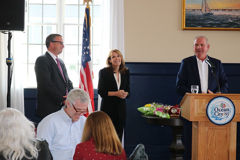 T Gallagher speaks about his wife and her accomplishments as Michele Gillian and Bill McMahon smile.