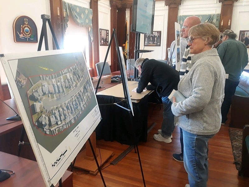 Residents look over the renderings for the project.