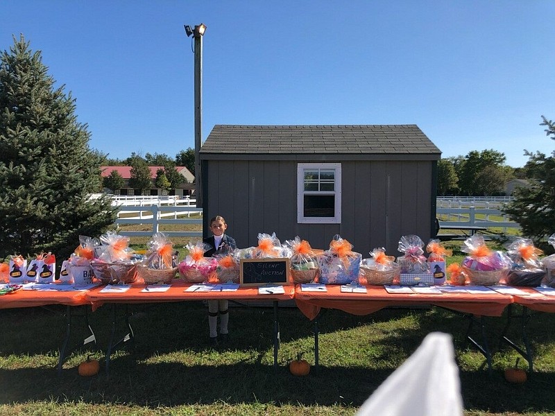 Regan Capone at Pembrook Farm for the Love of Linda Benefit horse show with silent auction baskets.