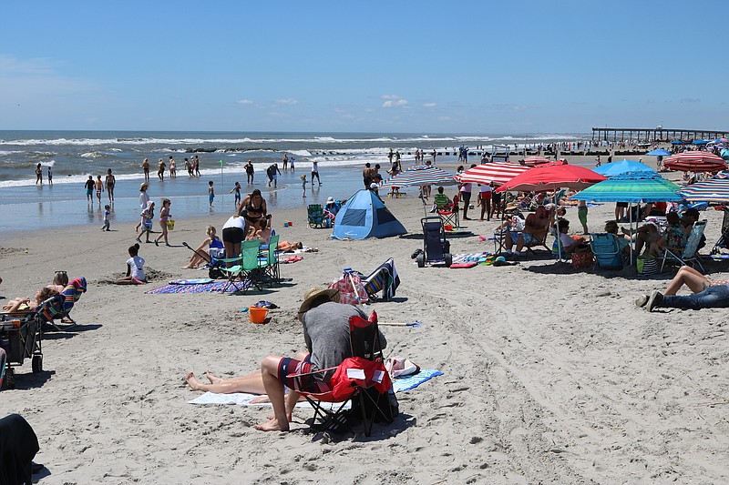 Crowds enjoy the beach.