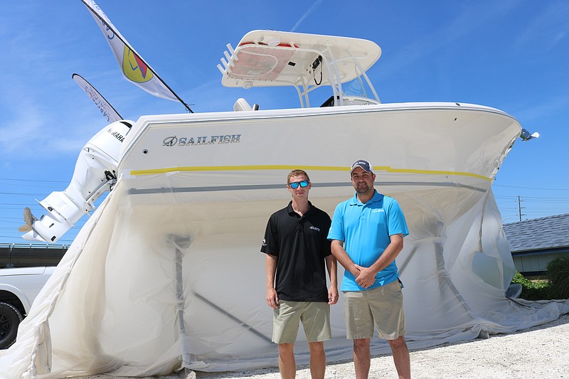 Dave Neville and Sean McNulty of Carefree Boat Club of South Jersey stand in front of one of their boats at the All Seasons Marina in Marmora.