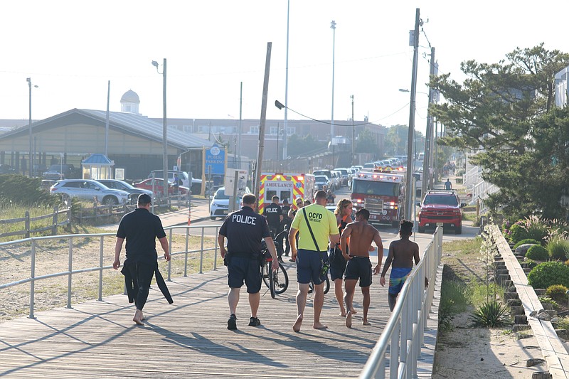 Emergency workers leave the scene after the rescues of three people, including a father and son in June 2022.