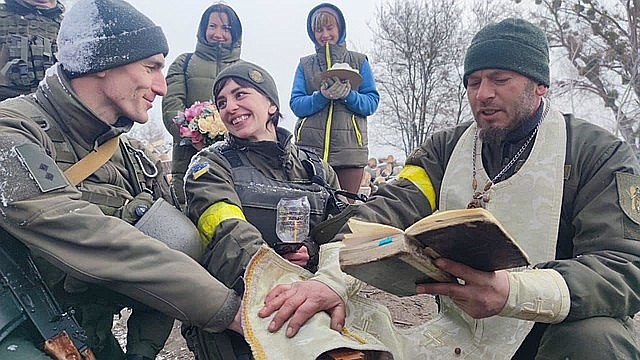 Ukrainian soldiers pray together.