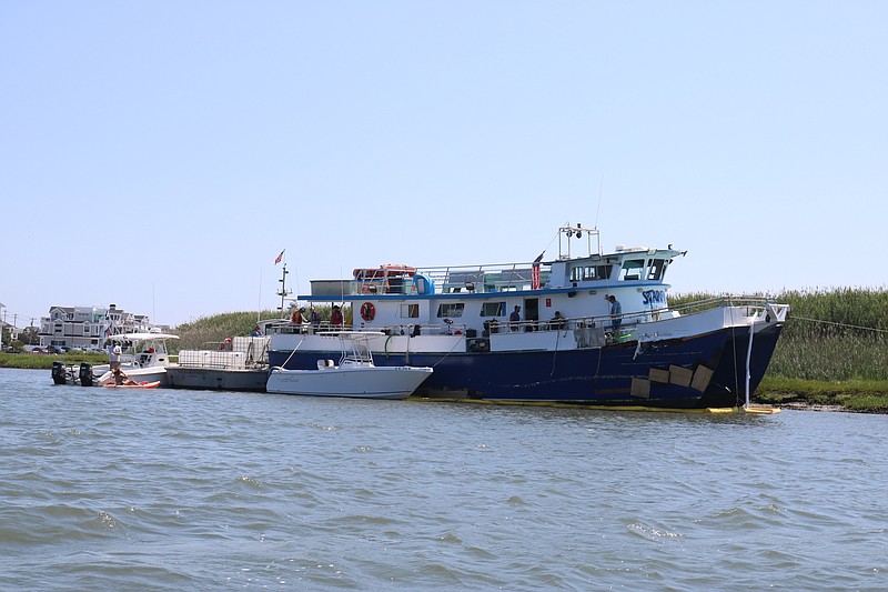 The Starfish charter boat remains grounded in shallow water in a channel in Sea Isle City while repairs are being done.