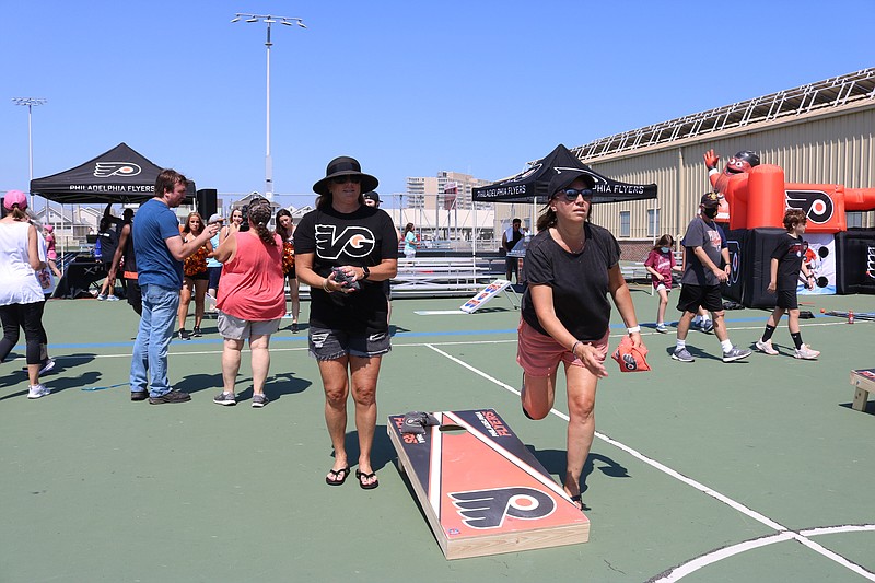 Suzy Krzaczek, left, and sister-in-law, Suzanne Loftus, both of Bucks County, Pa., play some baggo. 