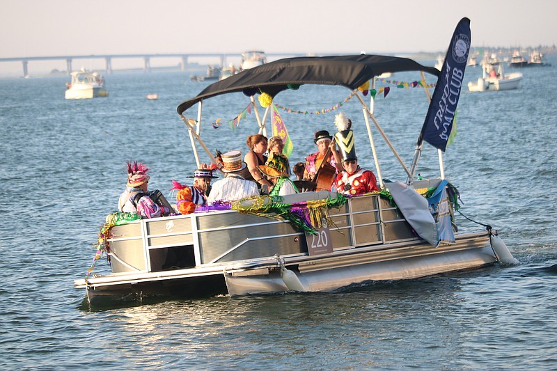 This tiki boat filled with Mummers looks like it could tip.