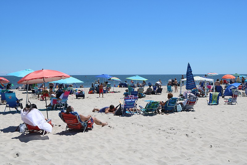 Visitors lounge at 34th Street beach in August.