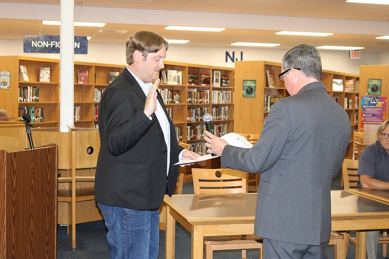 Ryan Leonard, of Ocean City, is sworn in by School business Administrator Tim Kelley to fill an unexpired term on the board vacated by Michael James.