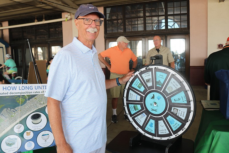 Environmental Commission Chairman Rick Bernardi shows a wheel attendees could spin to play a game for prizes at the 2022 Green Fair.