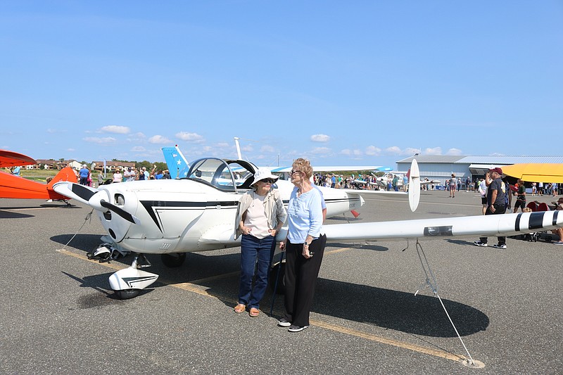 Spectators admire a vintage plane.